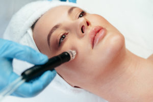 Beautiful woman getting facial skincare treatment in a cosmetic beauty clinic close up